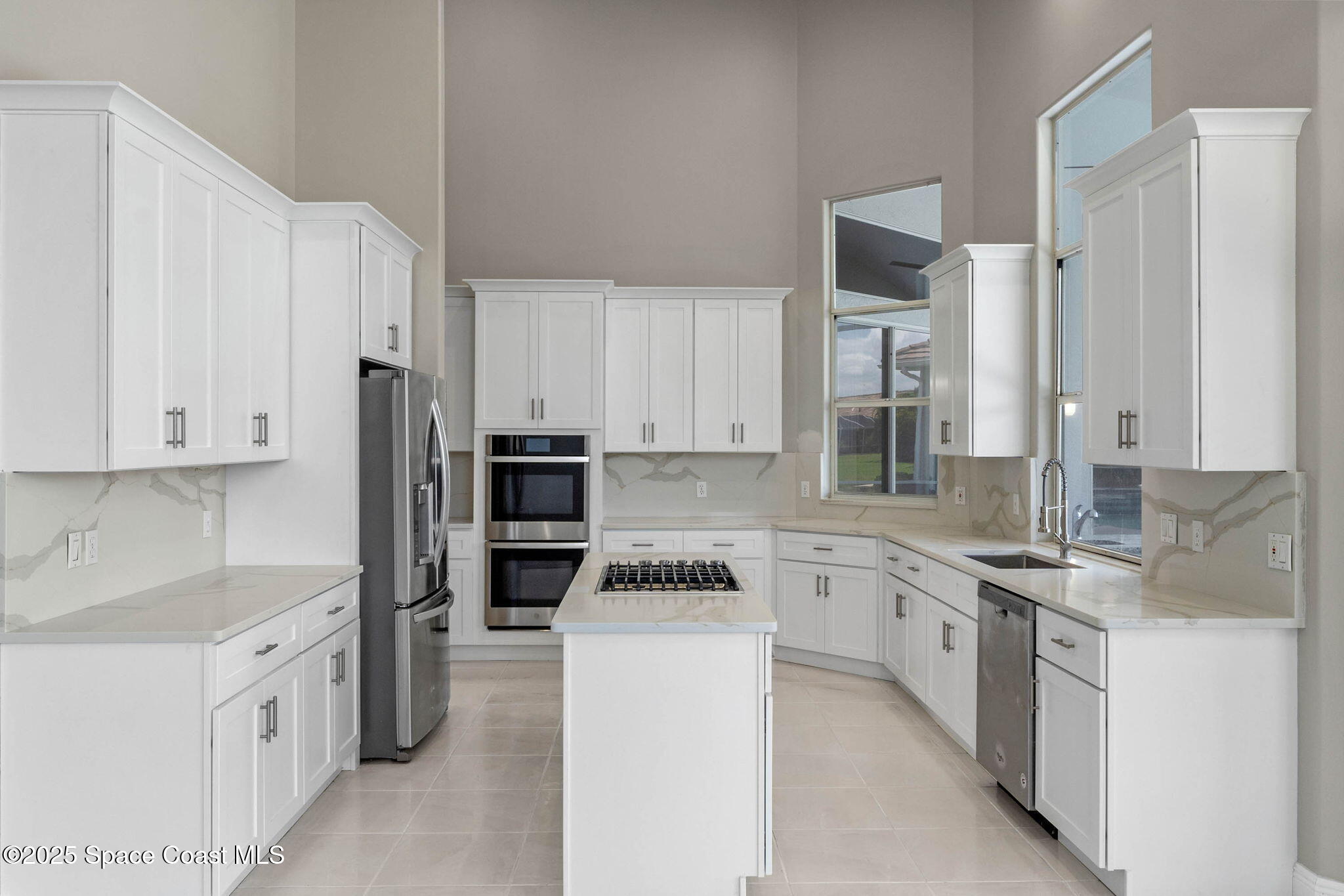 706 Palmer Way Melbourne, FL 32940 - Photo 14 of 43 a kitchen with granite countertop cabinets and refrigerator
