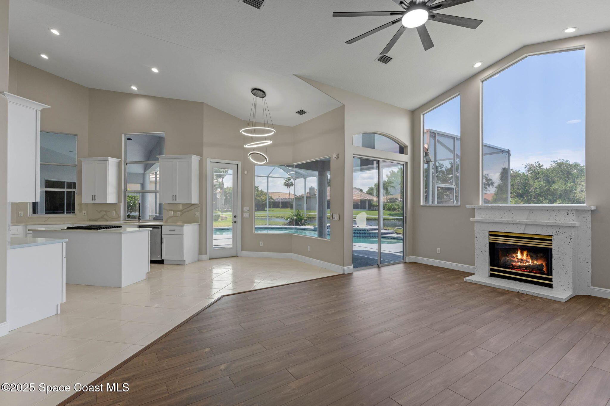 706 Palmer Way Melbourne, FL 32940 - Photo 15 of 43 a view of an empty room with wooden floor and a fireplace