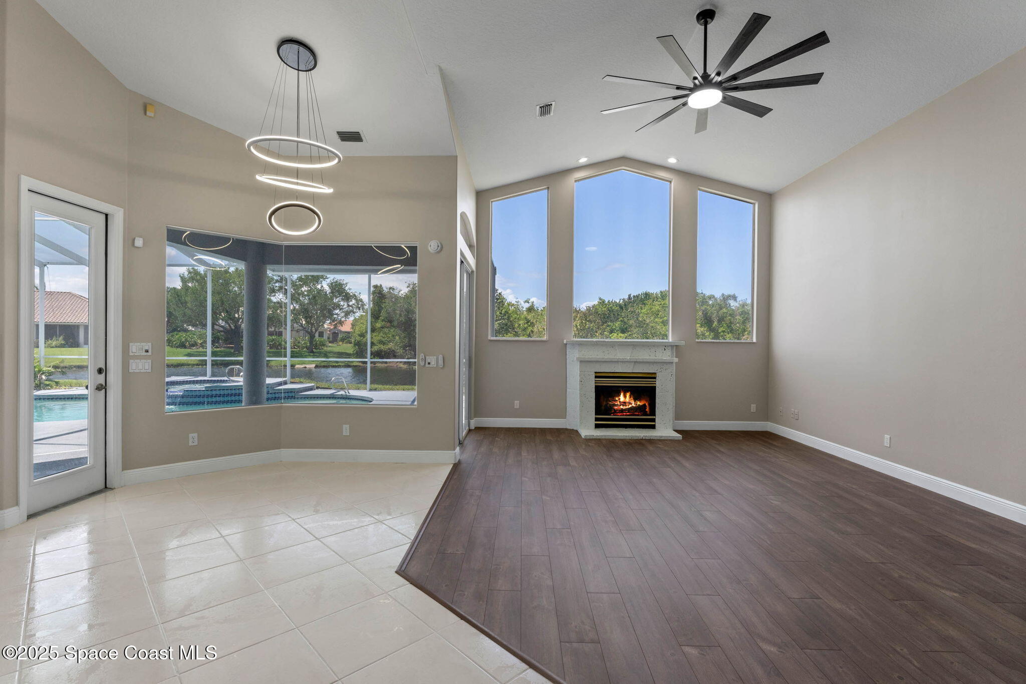 706 Palmer Way Melbourne, FL 32940 - Photo 16 of 43 a view of an empty room with a window and kitchen view
