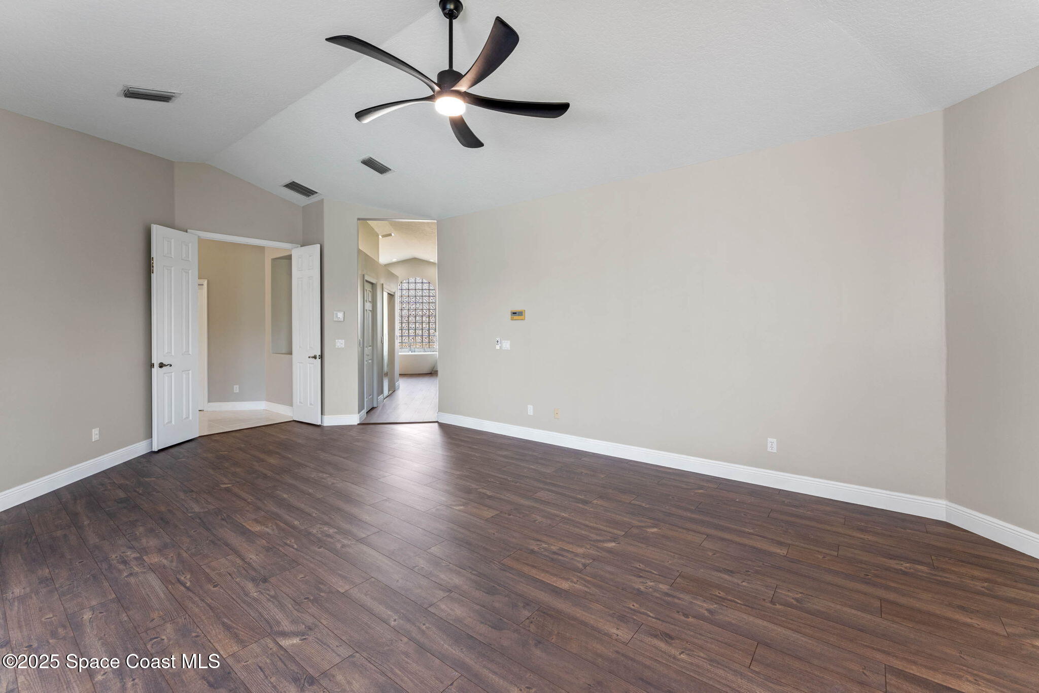 706 Palmer Way Melbourne, FL 32940 - Photo 20 of 43 an empty room with wooden floor and windows