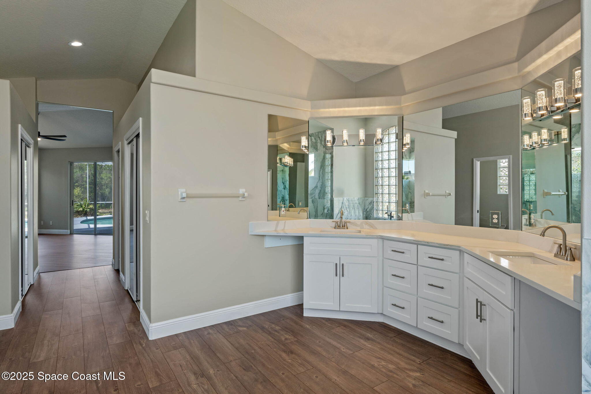 706 Palmer Way Melbourne, FL 32940 - Photo 23 of 43 a spacious bathroom with a double vanity sink a large mirror and shower