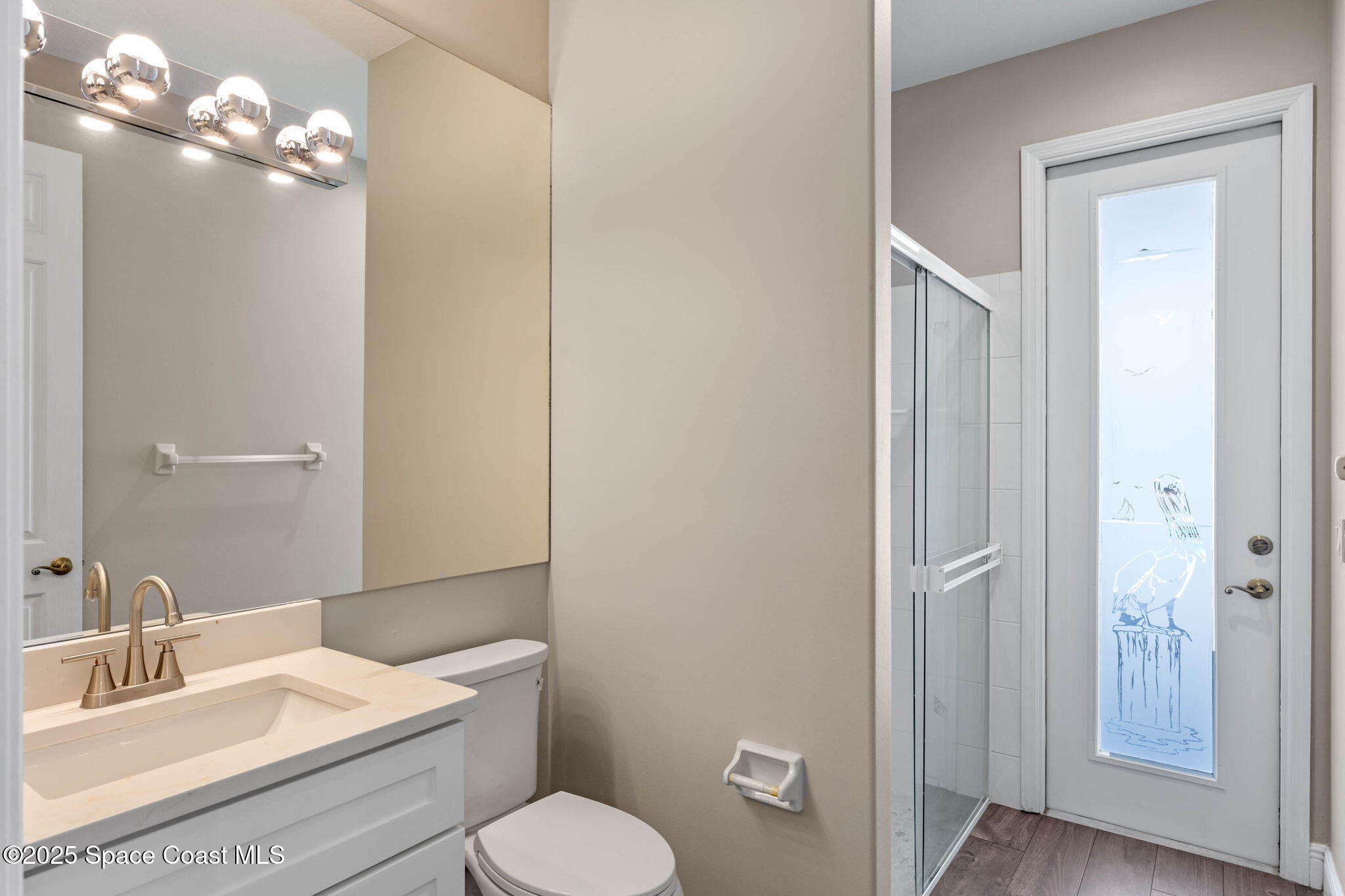 706 Palmer Way Melbourne, FL 32940 - Photo 33 of 43 a bathroom with a toilet a sink and mirror