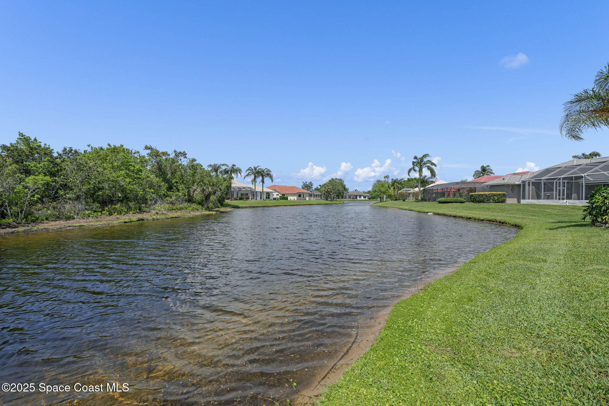 706 Palmer Way Melbourne, FL 32940 - Photo 39 of 43 a view of a lake with houses in the back