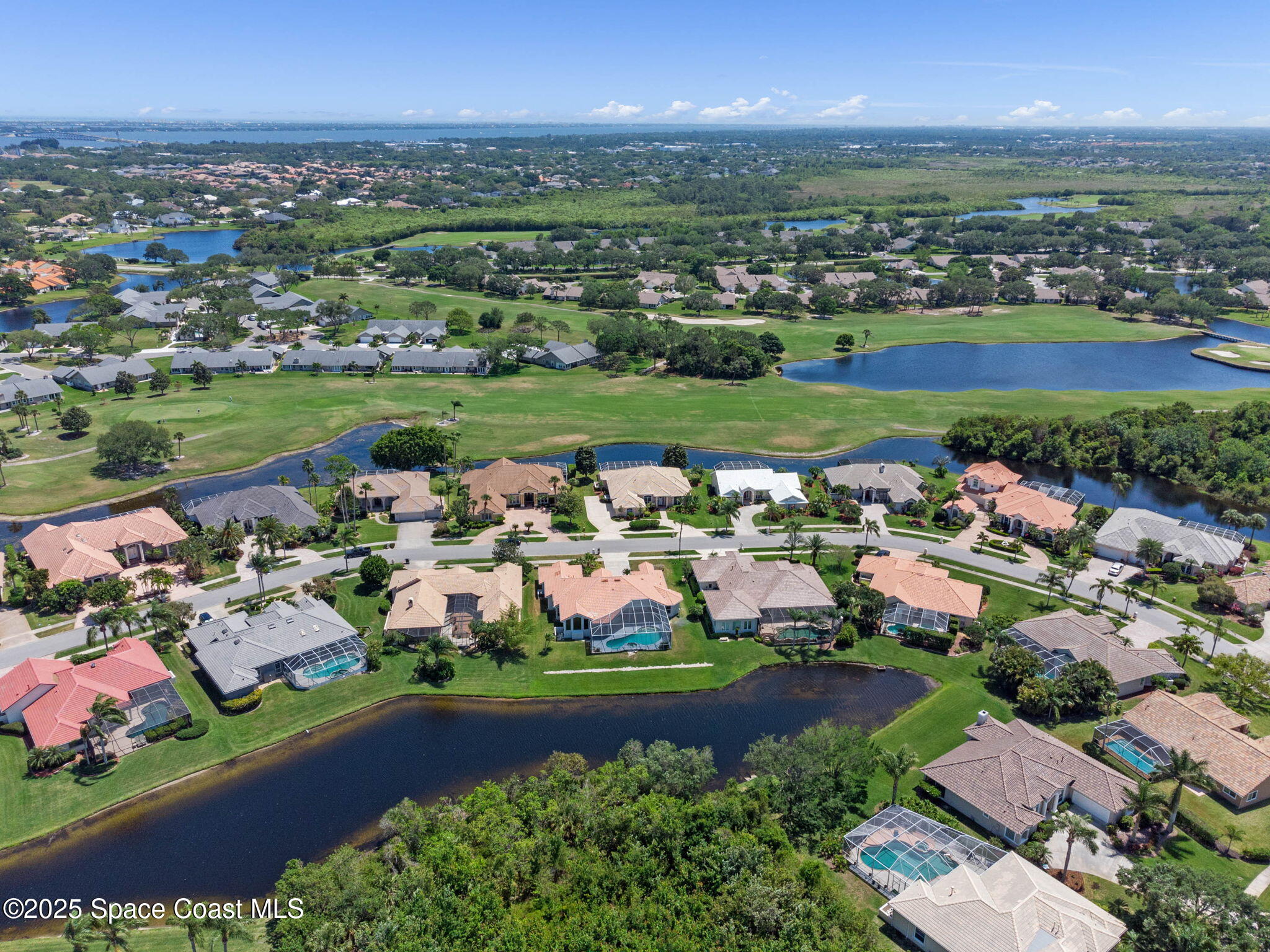 706 Palmer Way Melbourne, FL 32940 - Photo 41 of 43 an aerial view of a city with lots of residential buildings and mountain view in back
