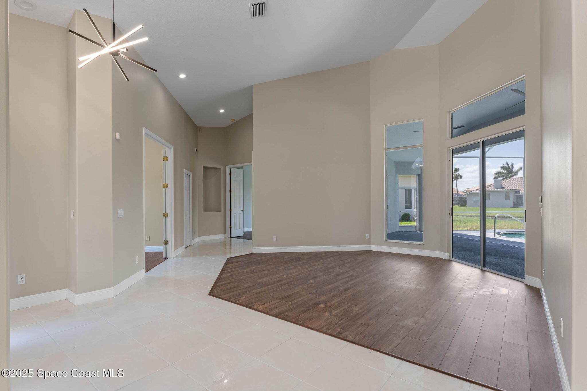 706 Palmer Way Melbourne, FL 32940 - Photo 8 of 43 an empty room with fan and a ceiling fan