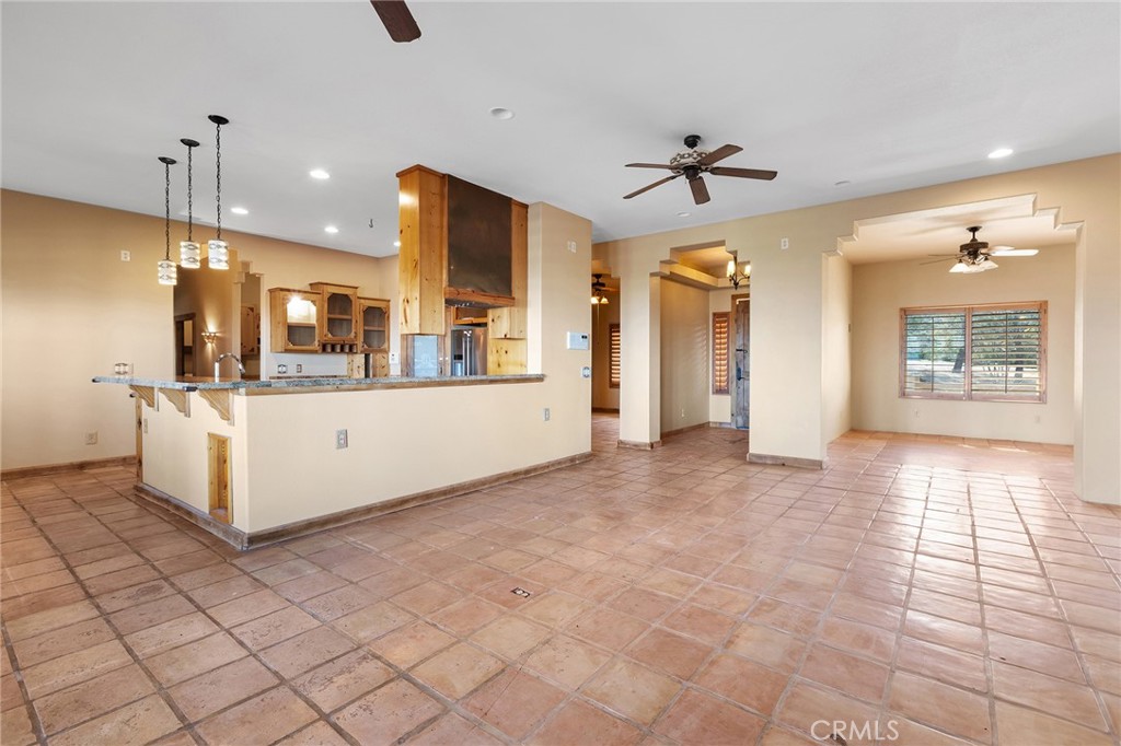 23032 Sky Mesa Road Homeland, CA 92548 - Photo 13 of 58 a view of a kitchen with kitchen island a counter top space appliances and a ceiling fan