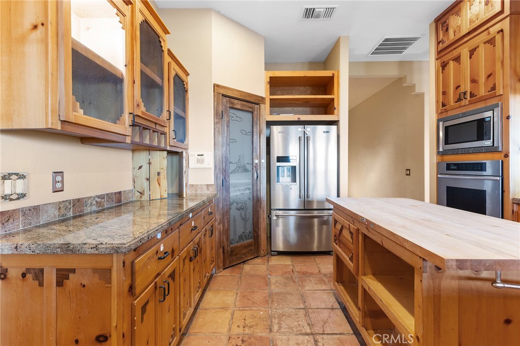 23032 Sky Mesa Road Homeland, CA 92548 - Photo 18 of 58 a kitchen with stainless steel appliances granite countertop a sink and refrigerator