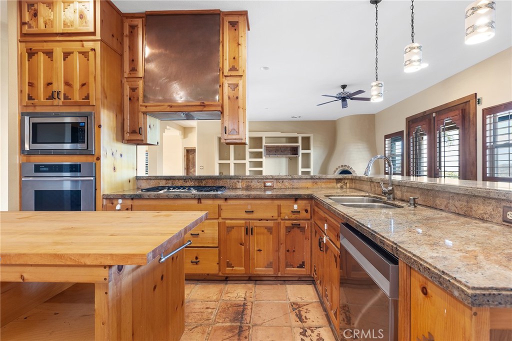23032 Sky Mesa Road Homeland, CA 92548 - Photo 19 of 58 a kitchen with stainless steel appliances granite countertop a sink and cabinets
