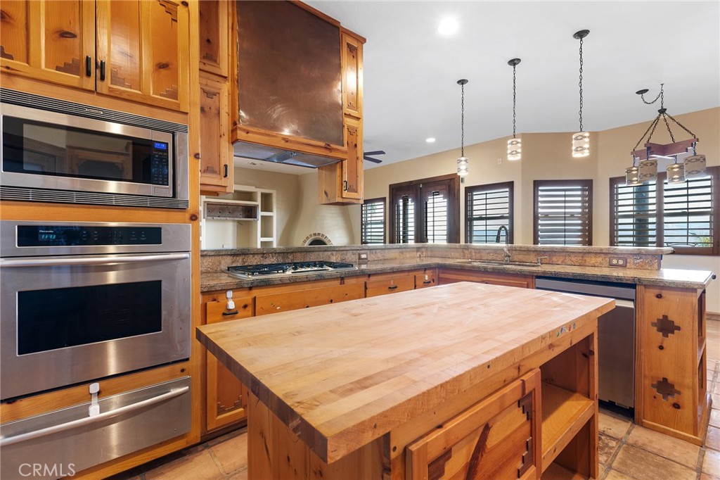 23032 Sky Mesa Road Homeland, CA 92548 - Photo 20 of 58 a kitchen with stainless steel appliances granite countertop a stove a oven and a refrigerator