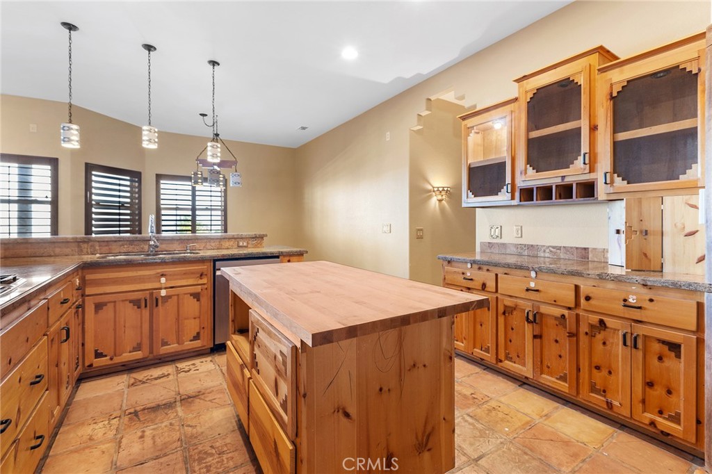 23032 Sky Mesa Road Homeland, CA 92548 - Photo 21 of 58 a kitchen with stainless steel appliances granite countertop a sink a stove and a wooden floor