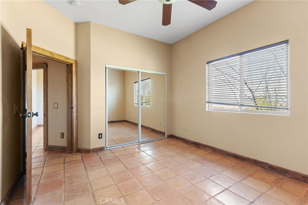 23032 Sky Mesa Road Homeland, CA 92548 - Photo 28 of 58 a view of an empty room with window and chandelier fan