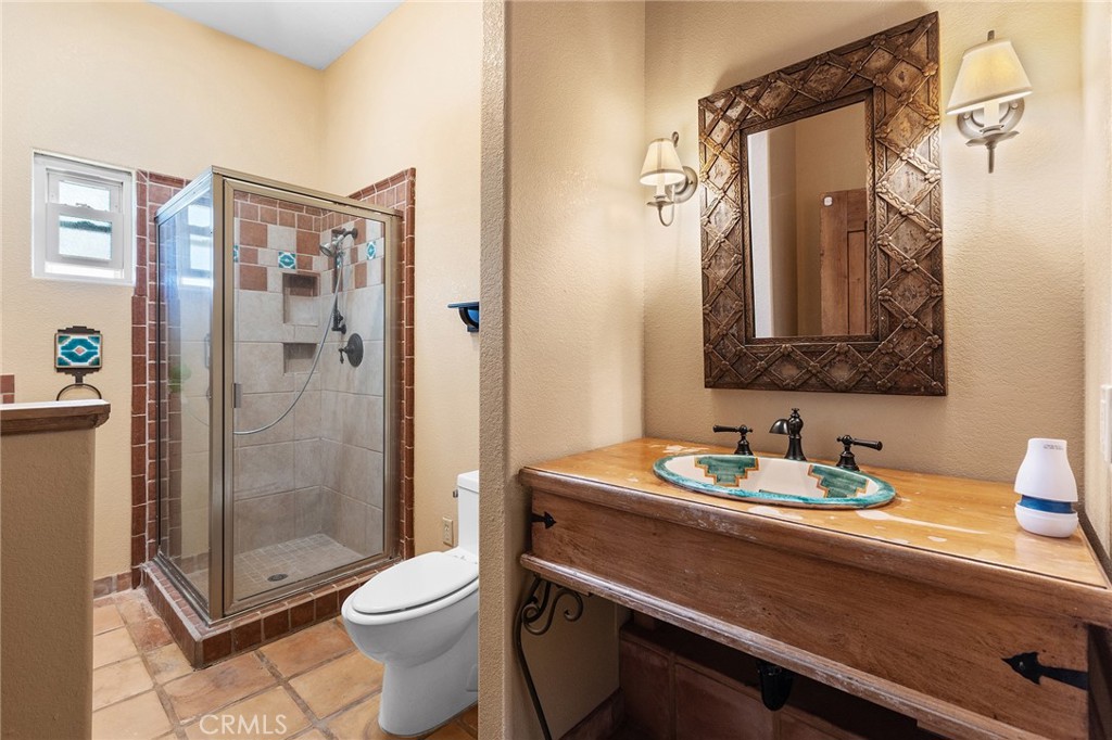 23032 Sky Mesa Road Homeland, CA 92548 - Photo 30 of 58 a bathroom with a toilet sink and shower