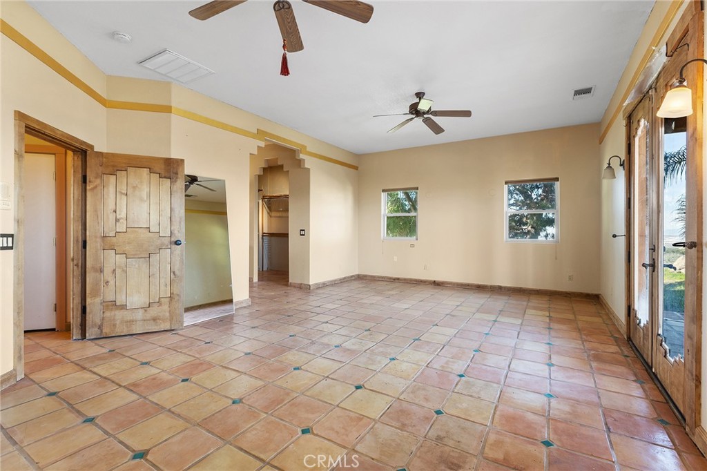 23032 Sky Mesa Road Homeland, CA 92548 - Photo 35 of 58 a view of a hallway with wooden floor and a chandelier fan