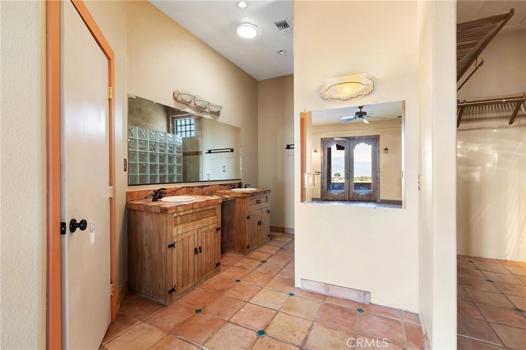 23032 Sky Mesa Road Homeland, CA 92548 - Photo 38 of 58 a bathroom with a sink a mirror and a toilet