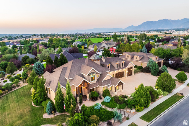694 West Cephus Road Draper, UT 84020 - Photo 2 of 148 Expansive property featuring a stone and stucco exterior, multiple gables, a paved driveway, and meticulously landscaped grounds with mature trees and shrubs