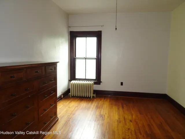 wooden floor and window in an empty room