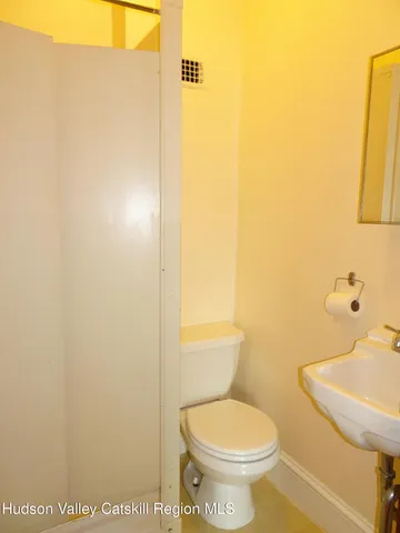 a white toilet sitting next to a bathroom sink