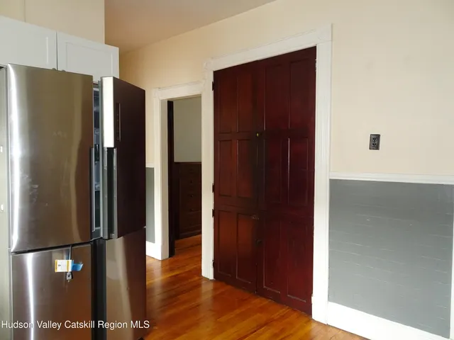 a view of a refrigerator in kitchen and wooden floor