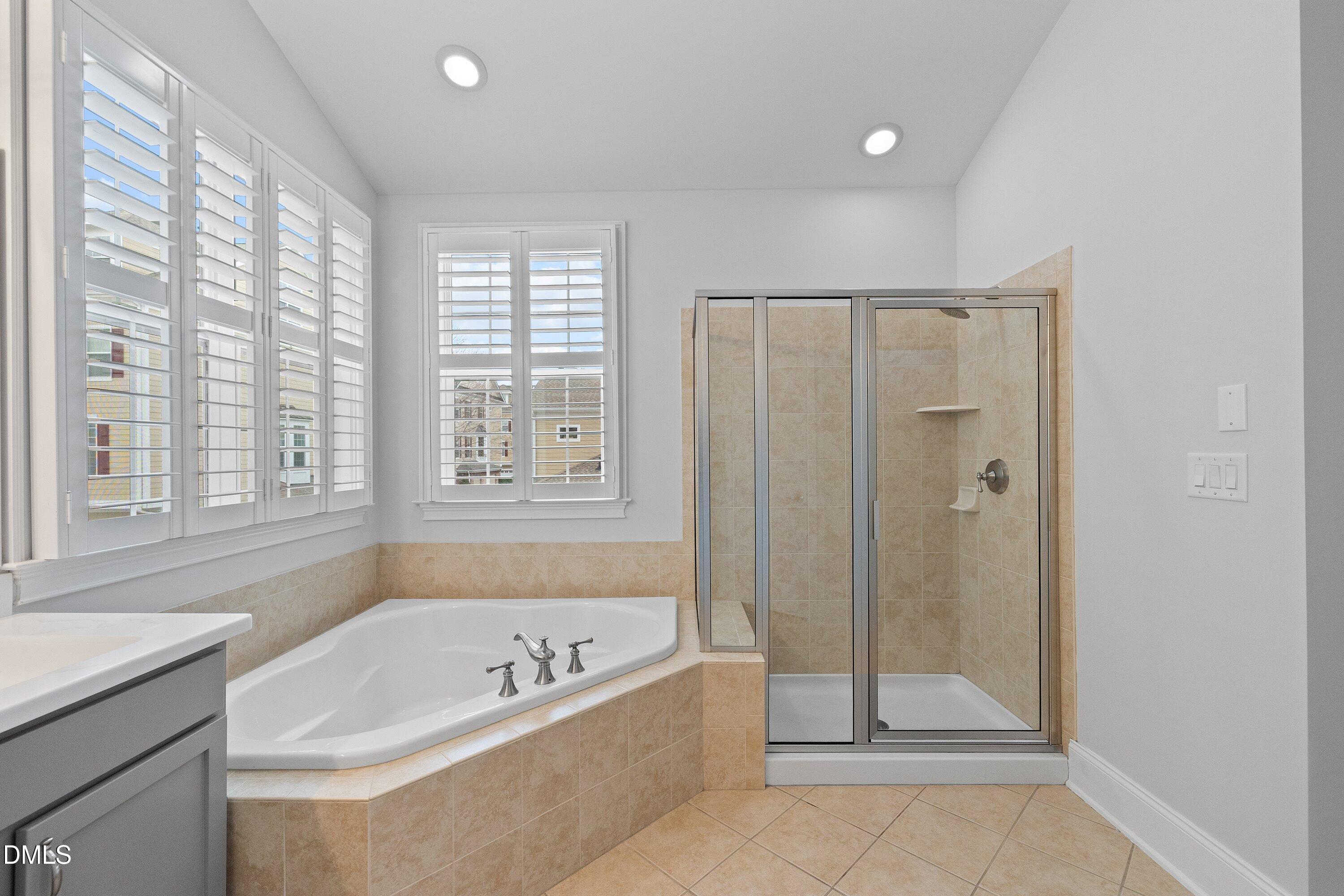 9211 Calabria Drive, Unit 205 Raleigh, NC 27617 - Photo 45 of 55 a bathroom with a tub a shower and a sink