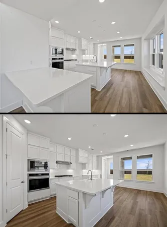 a view of kitchen with kitchen island and stainless steel appliances