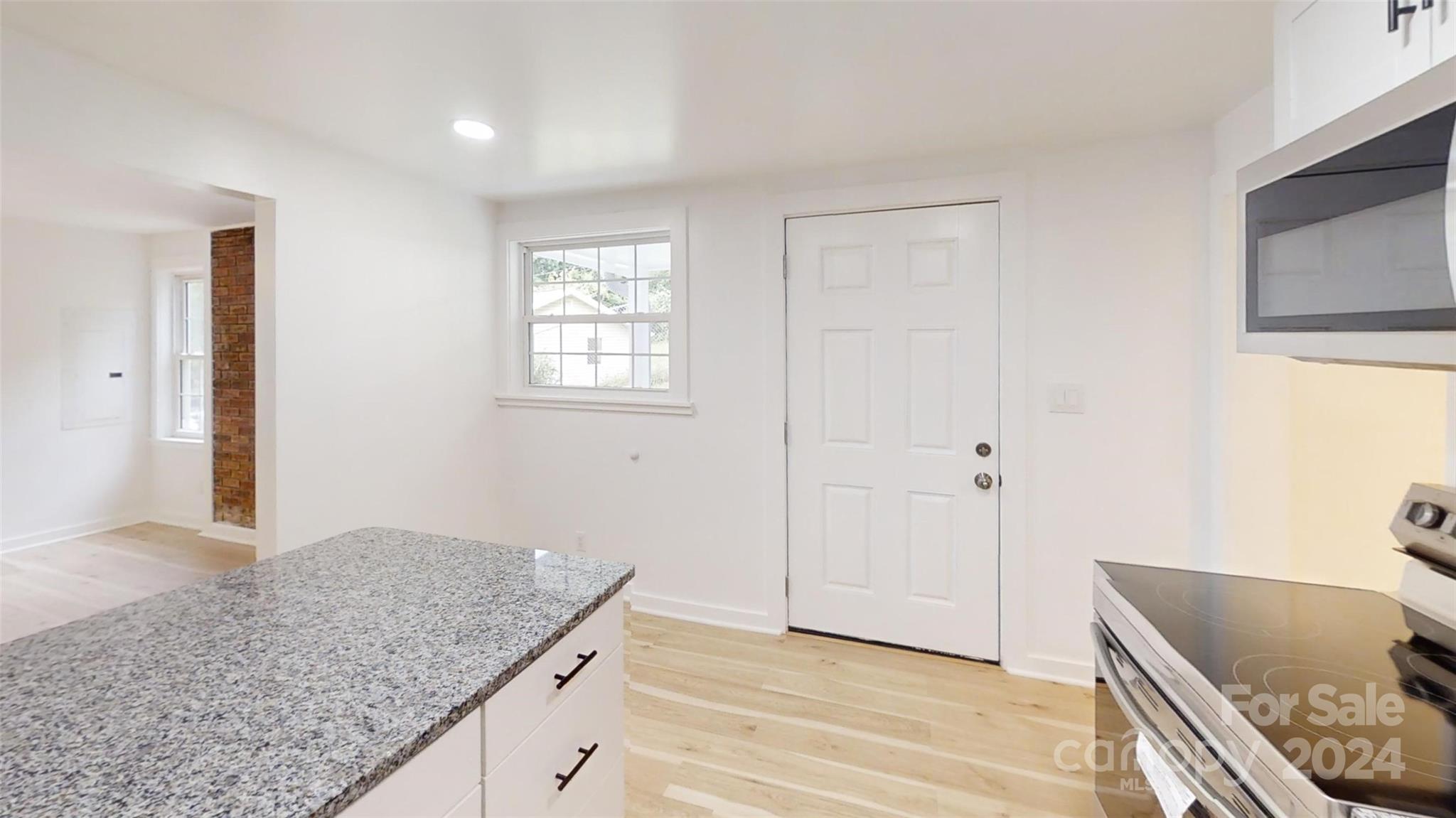 46 Lewis Street Canton, NC 28716 - Photo 12 of 27 a bathroom with a granite countertop sink and a mirror