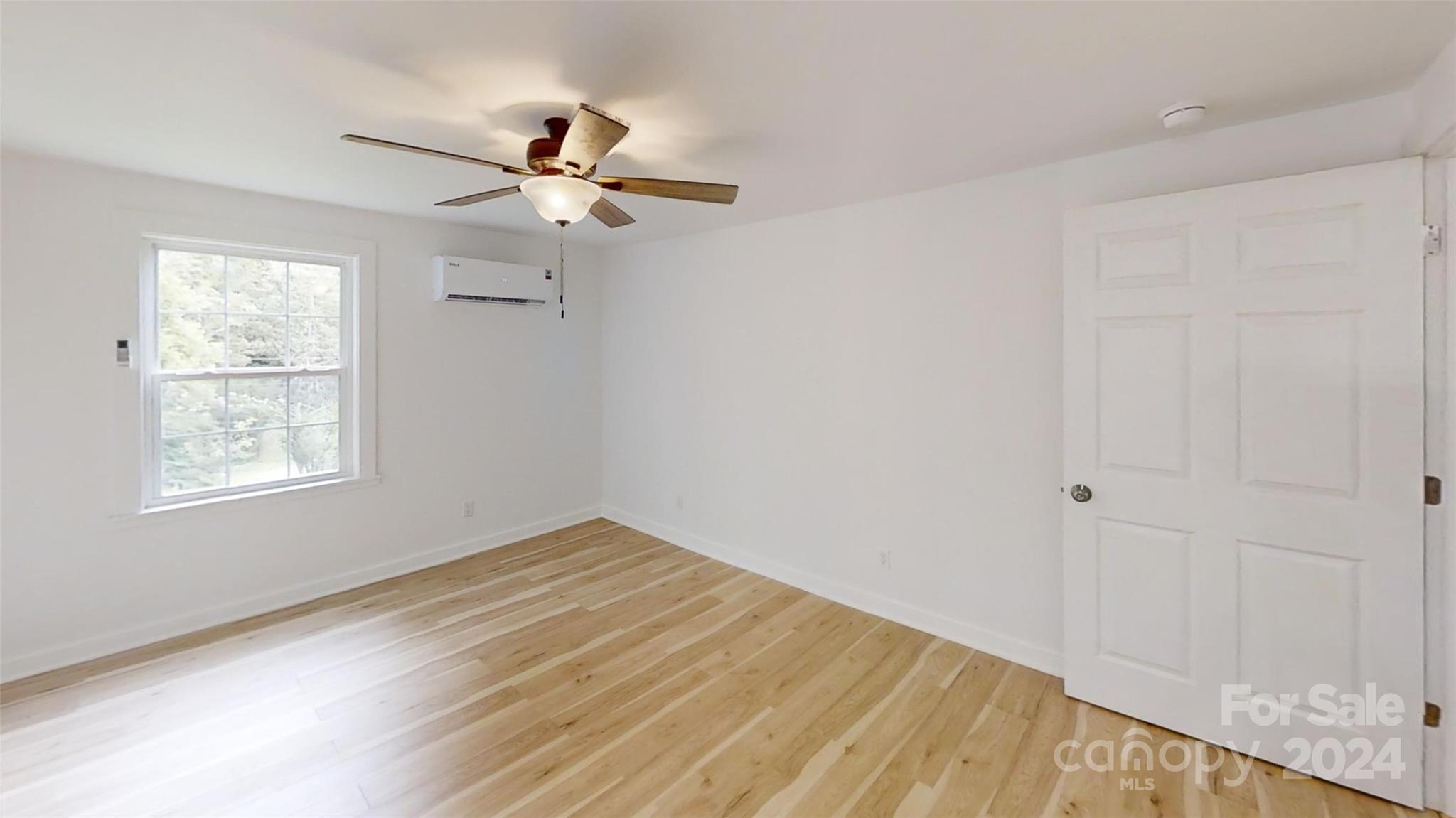 46 Lewis Street Canton, NC 28716 - Photo 16 of 27 an empty room with windows and fan