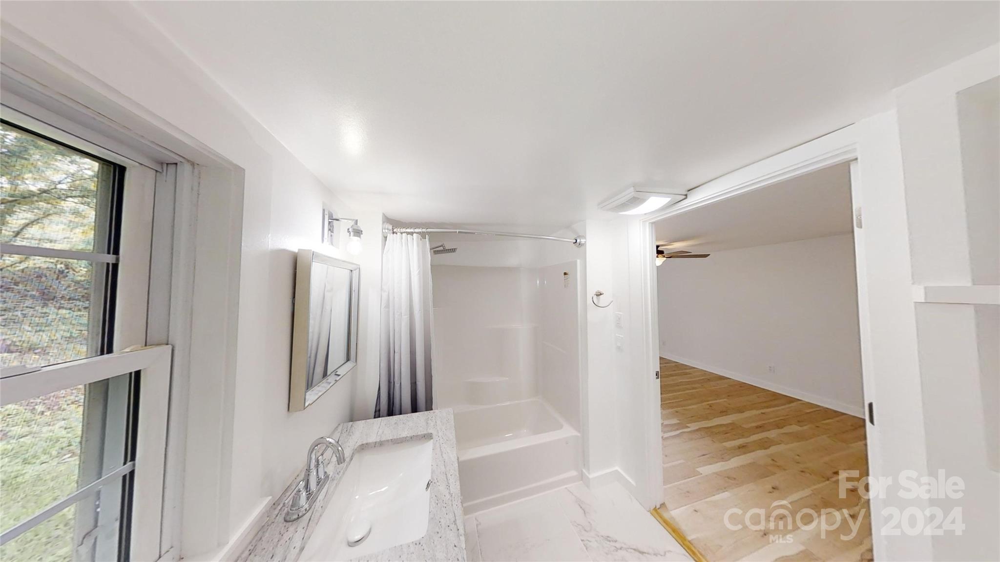 46 Lewis Street Canton, NC 28716 - Photo 17 of 27 a bathroom with a tub and shower view