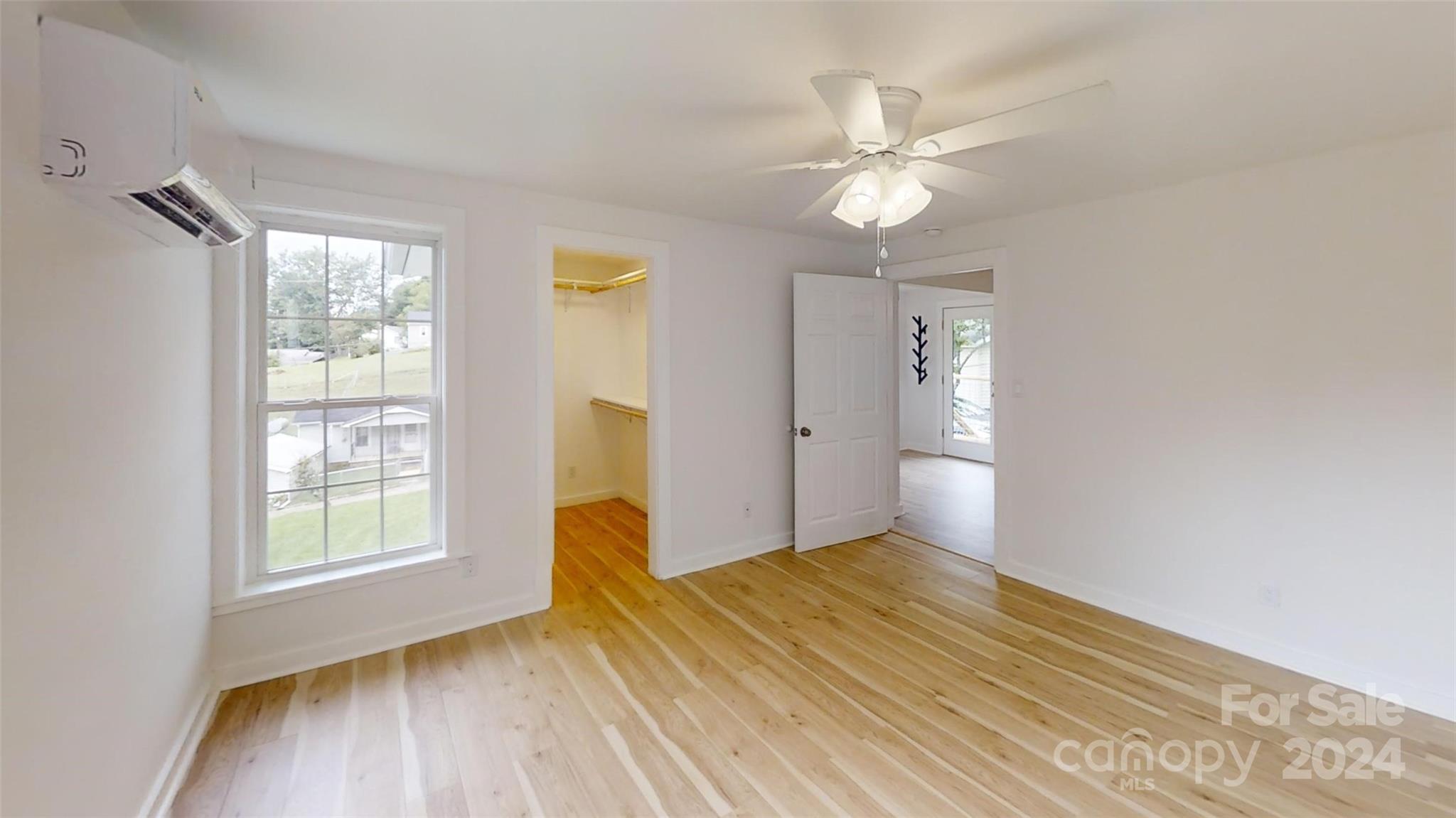 46 Lewis Street Canton, NC 28716 - Photo 19 of 27 a view of empty room with wooden floor and fan