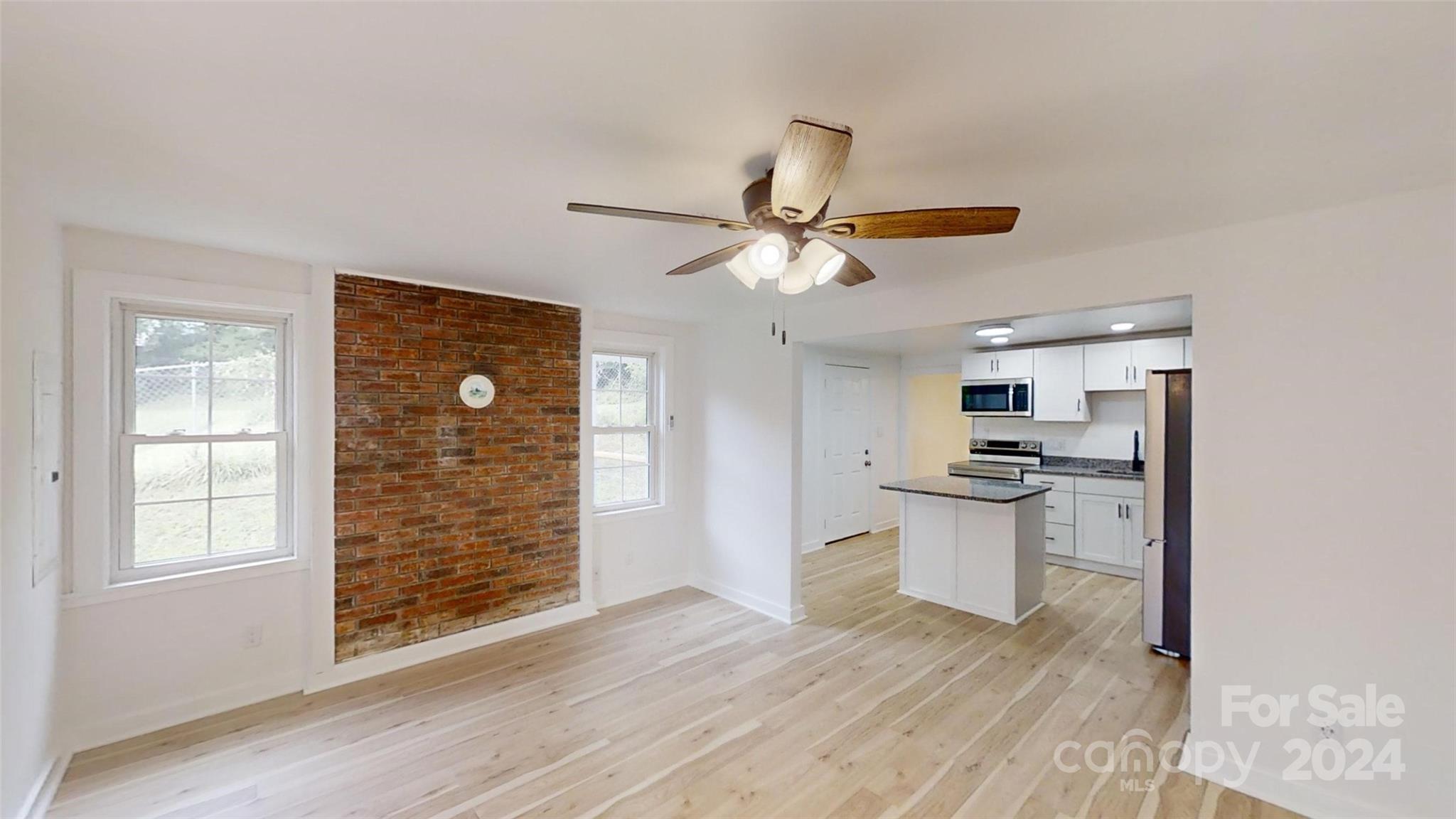 46 Lewis Street Canton, NC 28716 - Photo 10 of 27 a view of kitchen with sink microwave and cabinets