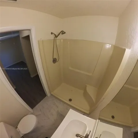 a bathroom with a shower and toilet
