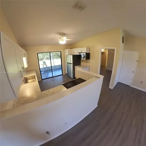 a kitchen with sink and refrigerator