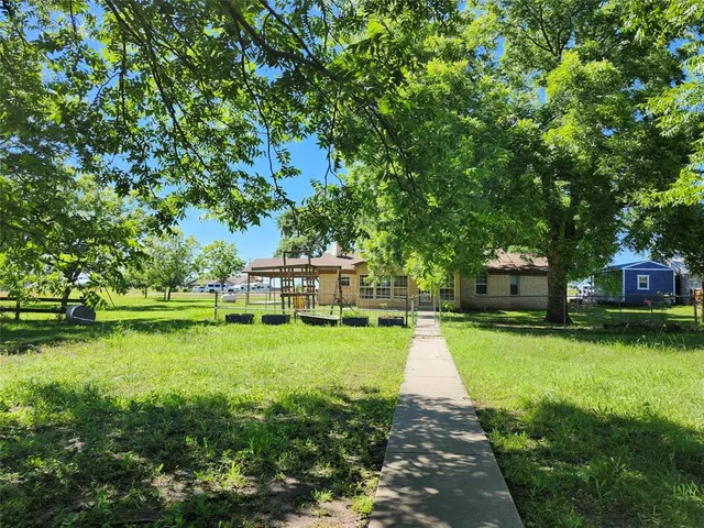 a front view of a house with a yard table and chairs