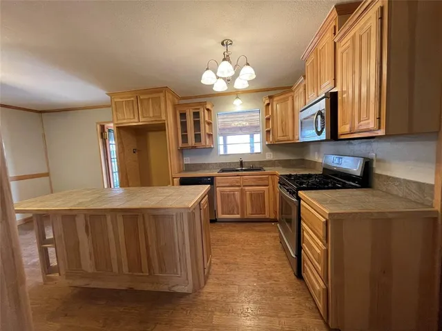 a kitchen with a stove a sink and a refrigerator