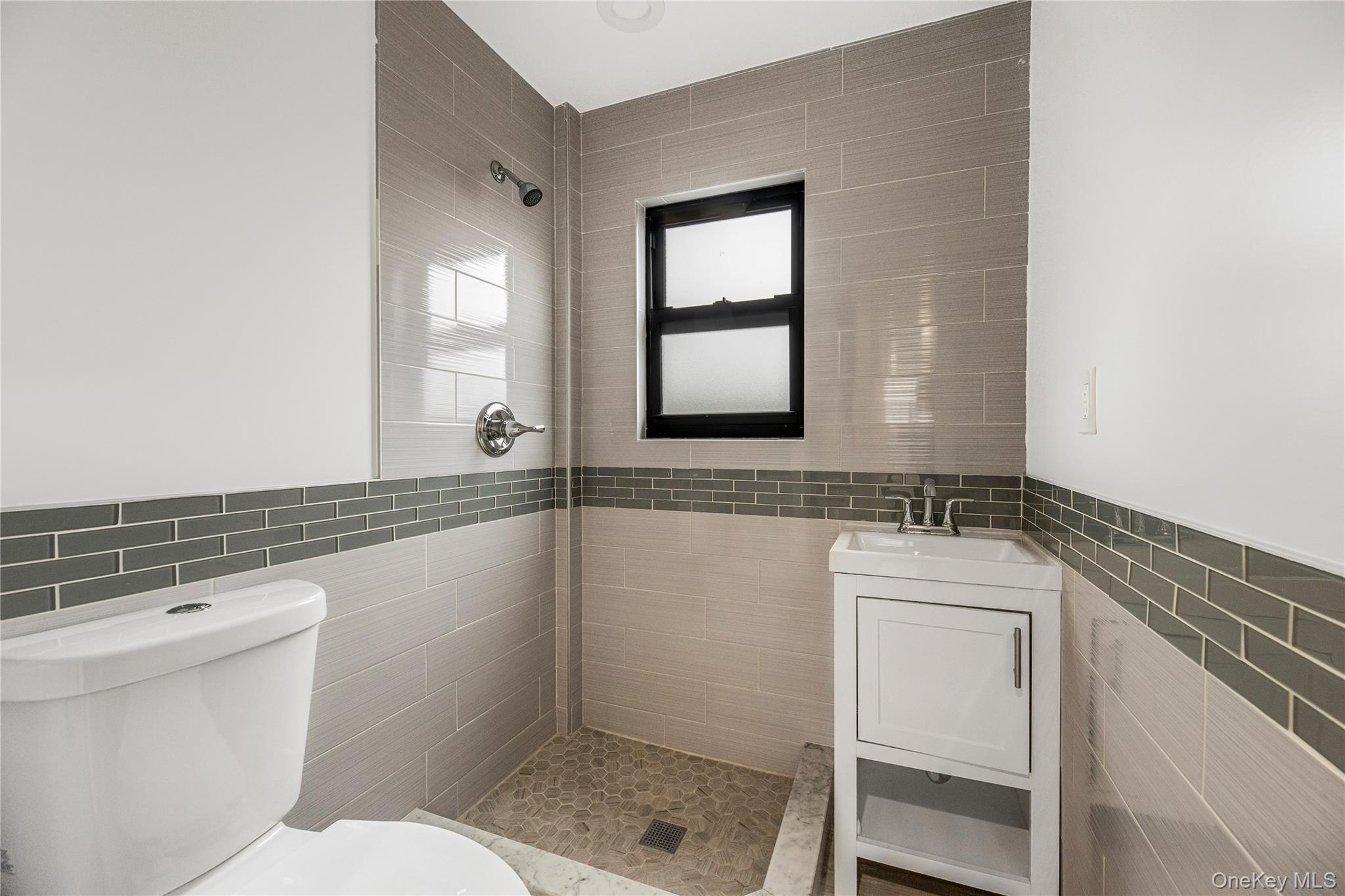 3067 Williamsbridge Road Bronx, NY 10467 - Photo 22 of 29 a bathroom with a granite countertop toilet a sink and mirror