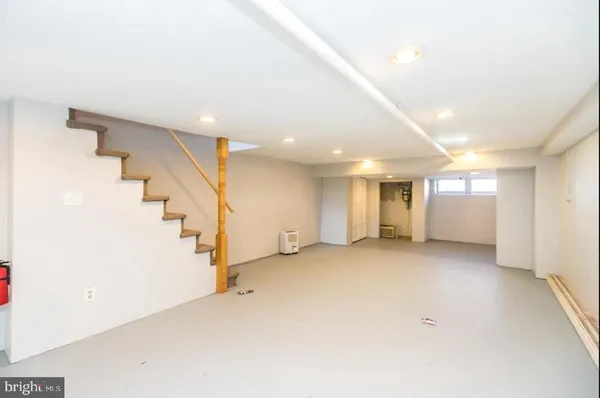 an empty room with stairs and white walls