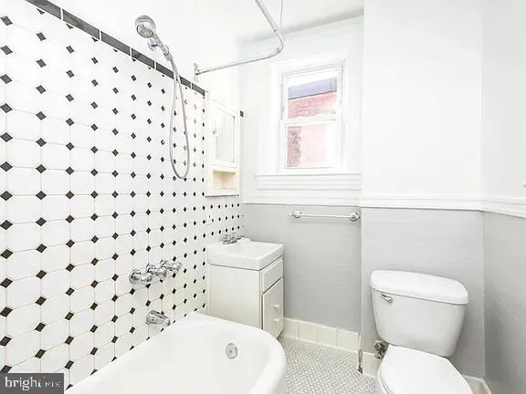 a white toilet sitting next to a bathroom sink