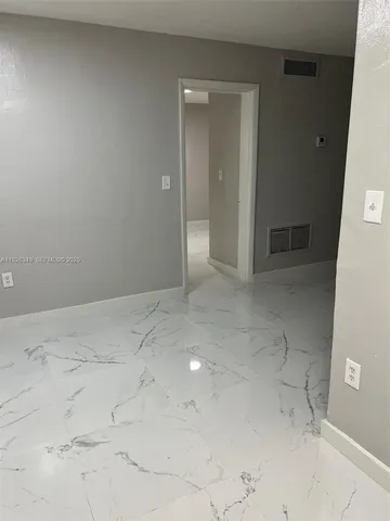 a bathroom with a granite countertop sink and a shower