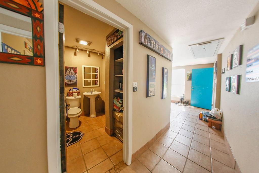 6730 Pine Mill Road Reno, TX 75462 - Photo 13 of 21 Hall featuring rail lighting, attic access, light tile patterned flooring, and a sink