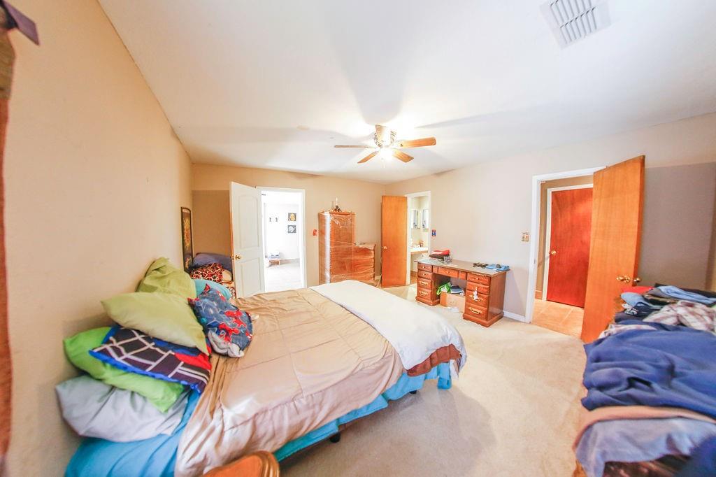 6730 Pine Mill Road Reno, TX 75462 - Photo 14 of 21 Bedroom with light carpet and ceiling fan