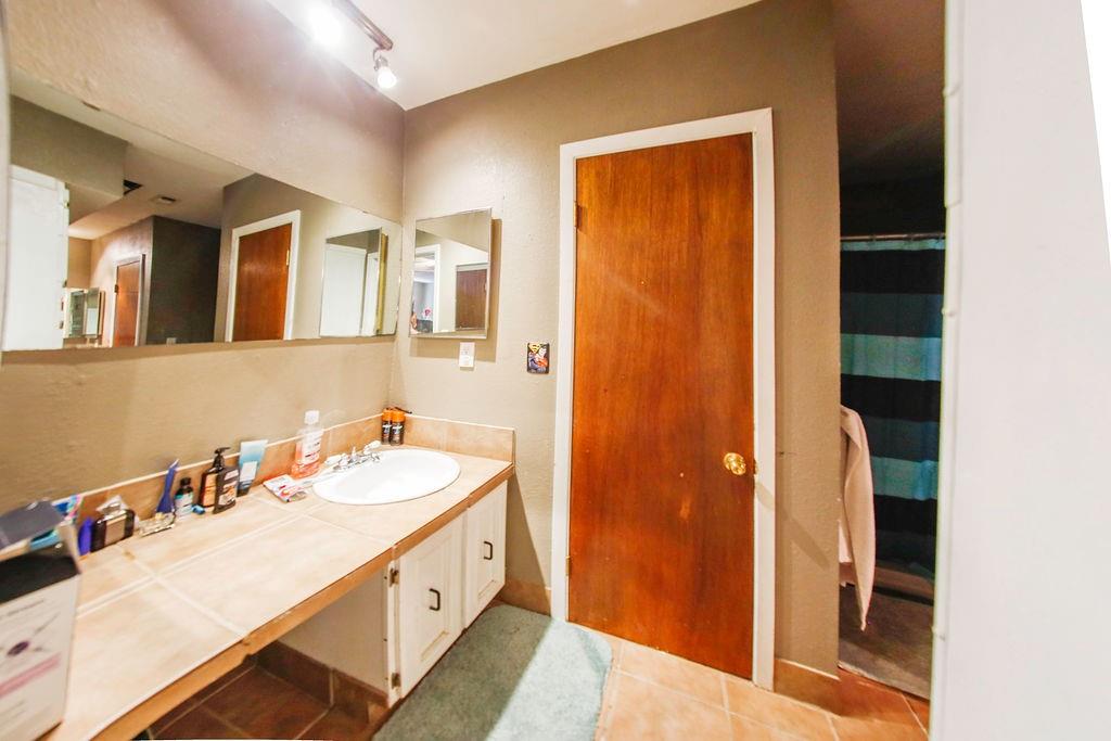 6730 Pine Mill Road Reno, TX 75462 - Photo 16 of 21 Bathroom featuring tile patterned floors and vanity