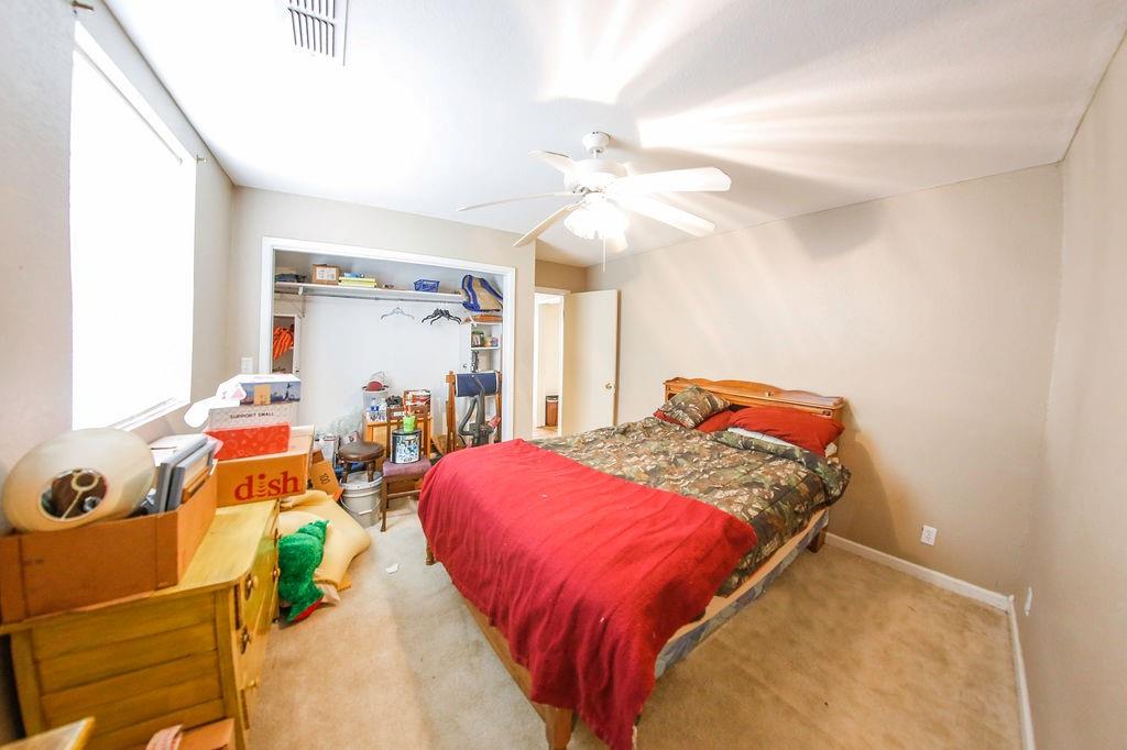 6730 Pine Mill Road Reno, TX 75462 - Photo 17 of 21 Bedroom featuring carpet, a closet, and ceiling fan