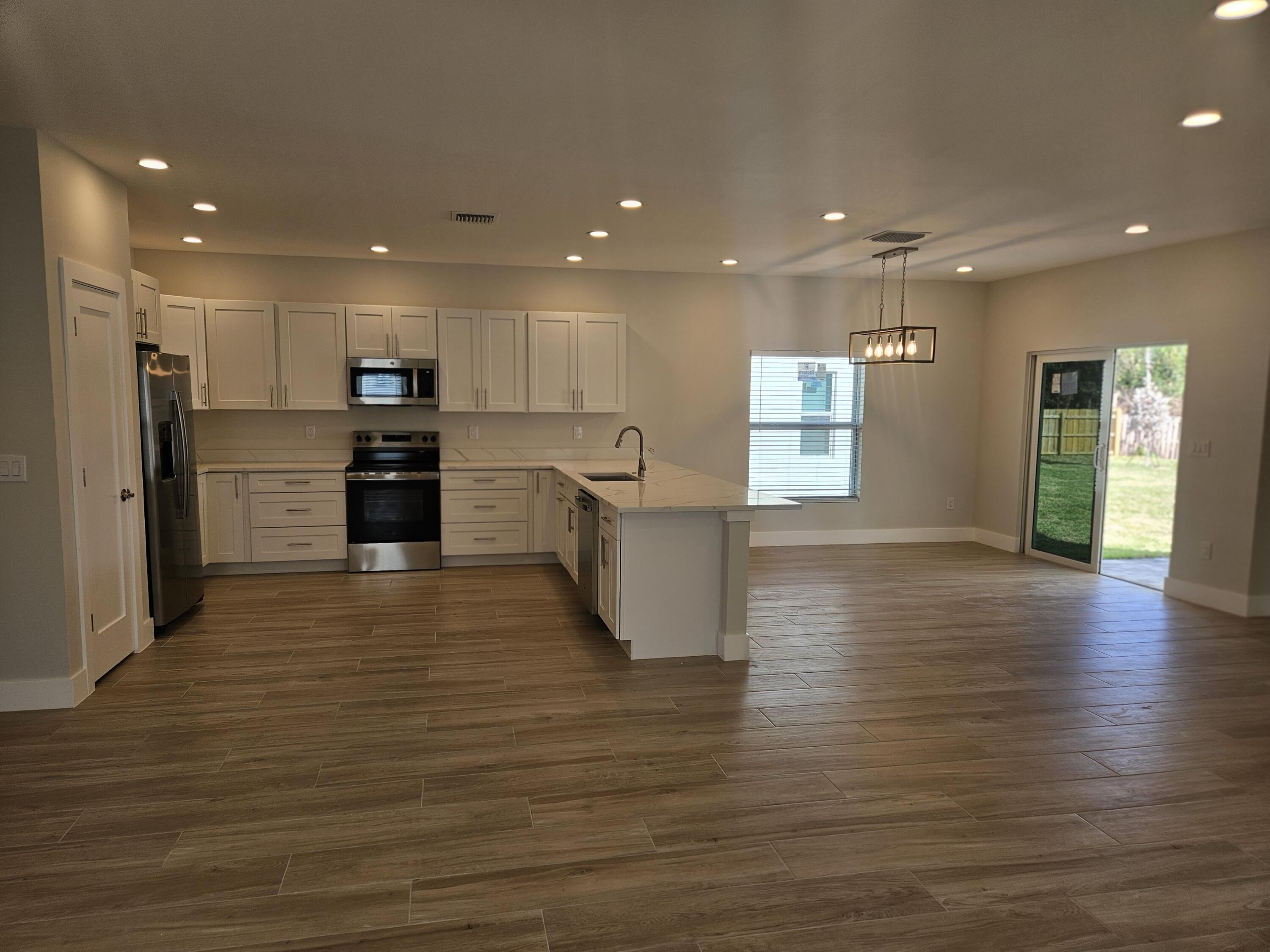 3838 Southeast Grant Street Stuart, FL 34997 - Photo 14 of 39 a view of a kitchen with a sink and a large window