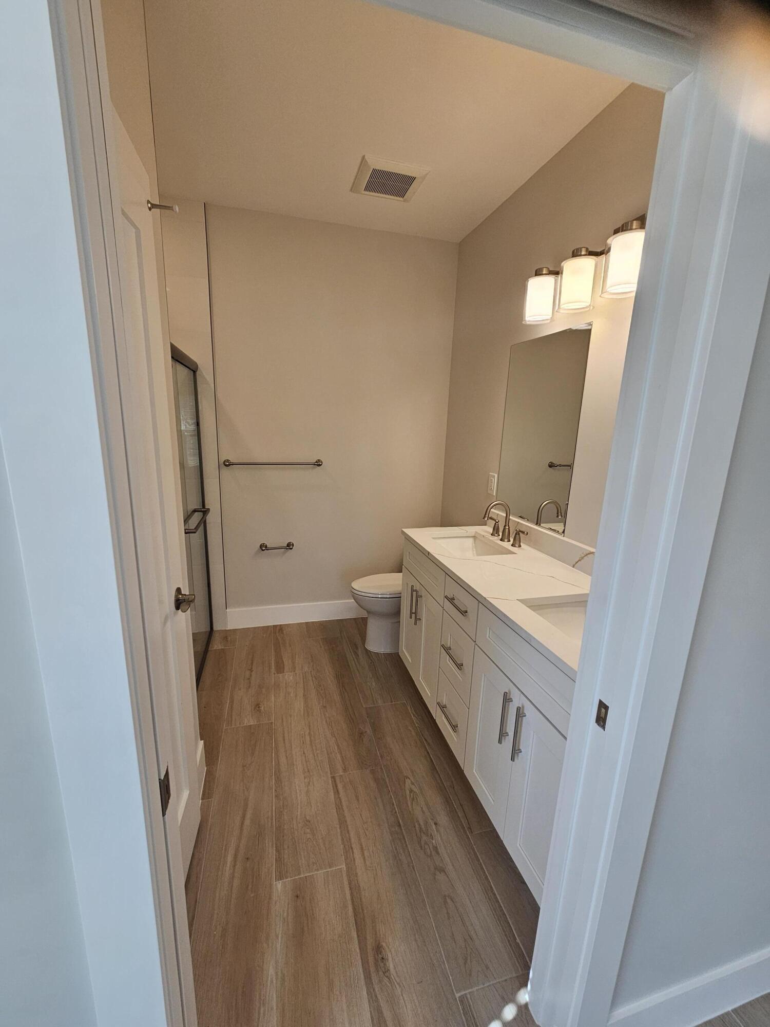 3838 Southeast Grant Street Stuart, FL 34997 - Photo 25 of 39 a bathroom with a sink a mirror and a toilet