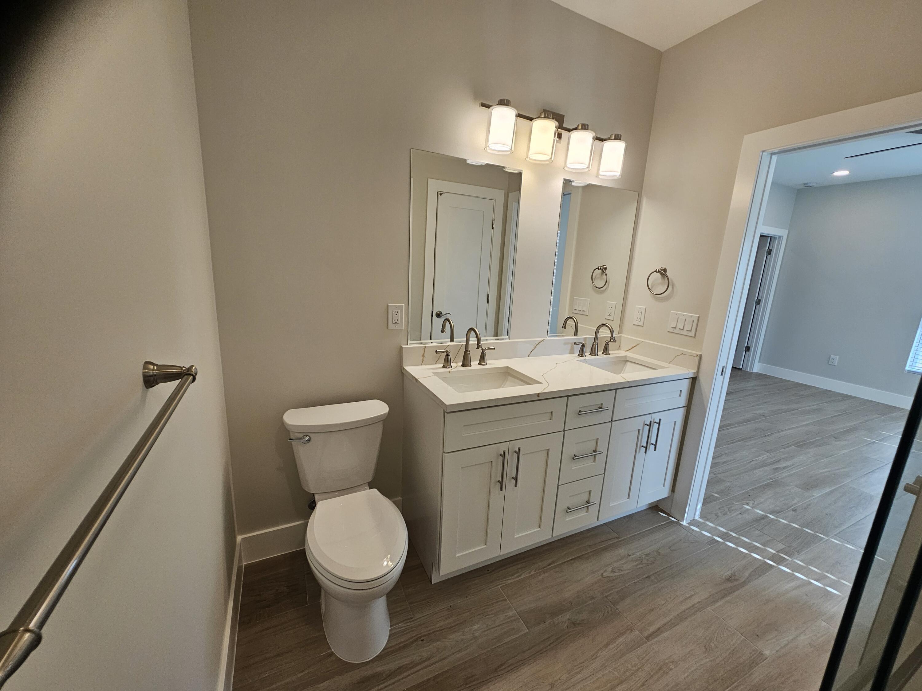 3838 Southeast Grant Street Stuart, FL 34997 - Photo 26 of 39 a bathroom with a toilet sink and mirror
