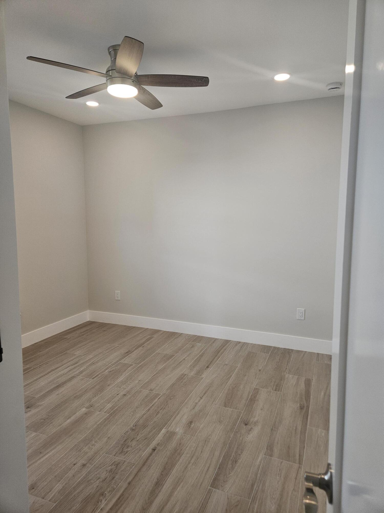 3838 Southeast Grant Street Stuart, FL 34997 - Photo 30 of 39 a view of an empty room with wooden floor