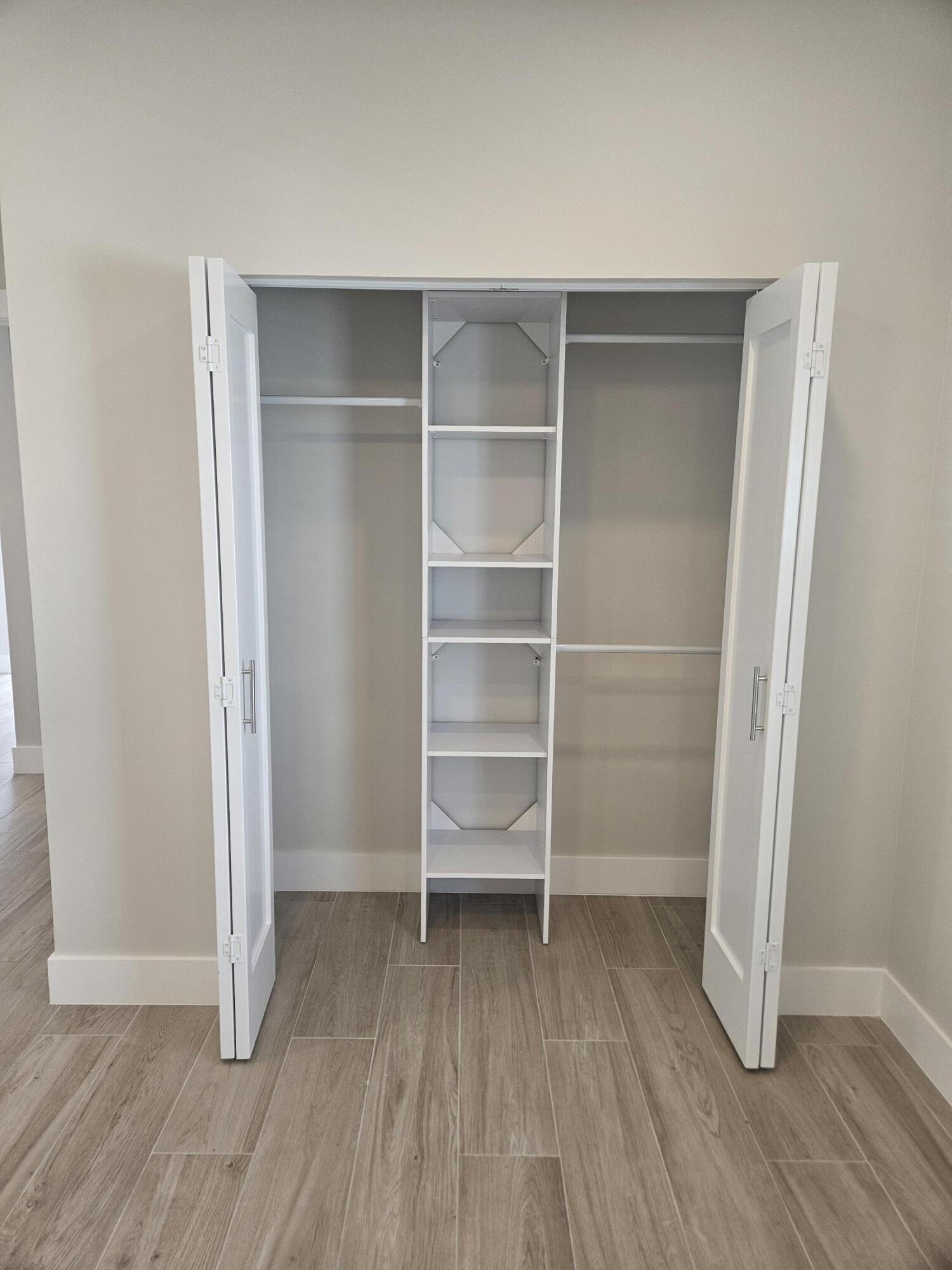3838 Southeast Grant Street Stuart, FL 34997 - Photo 32 of 39 a view of walk in closet with empty racks