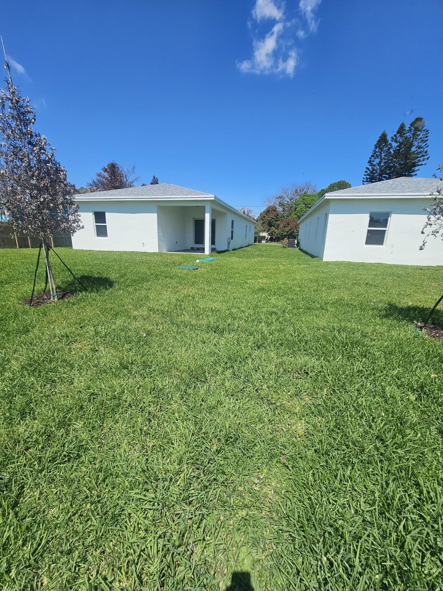 3838 Southeast Grant Street Stuart, FL 34997 - Photo 6 of 39 a front view of a house with a yard