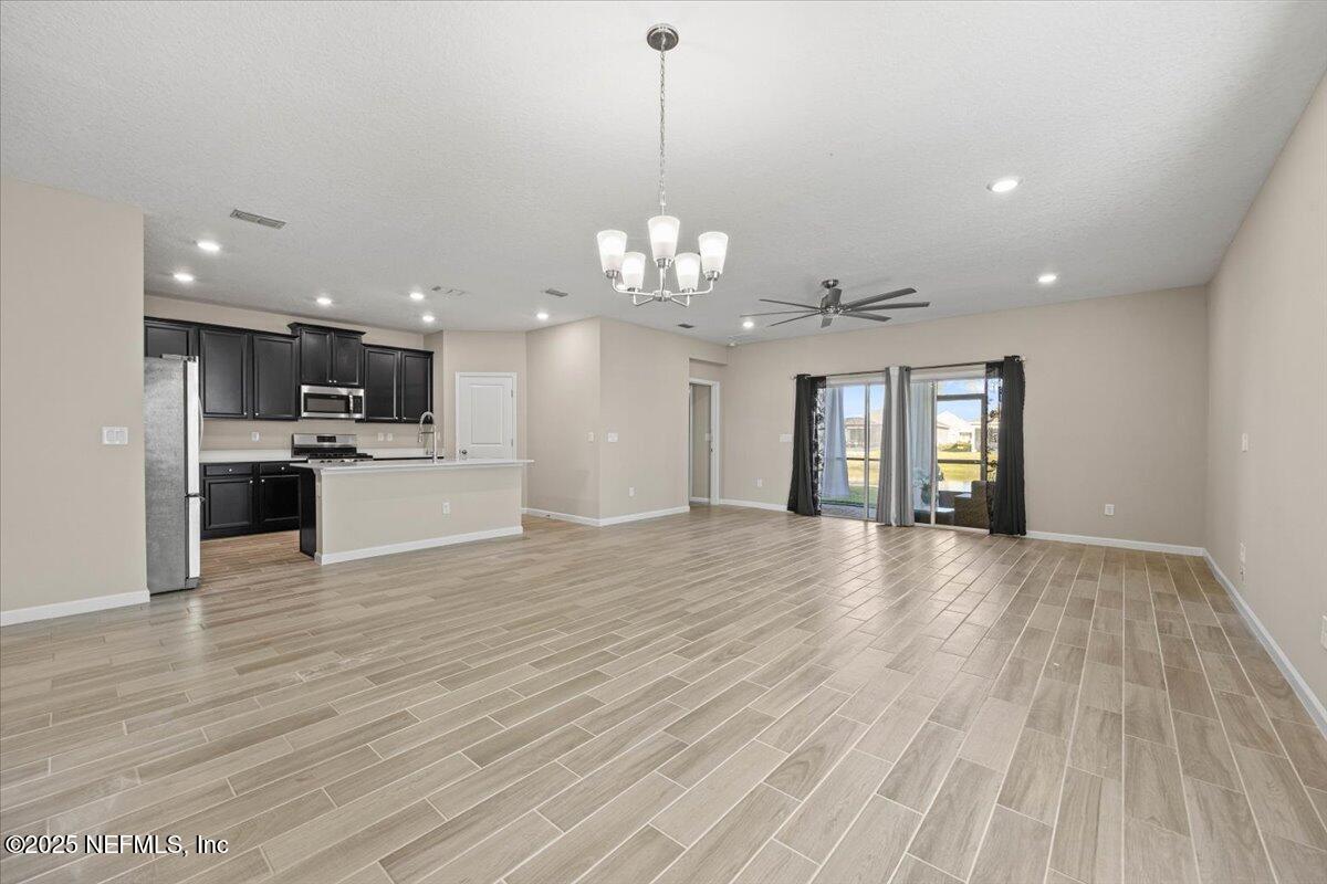 1728 Amberly Drive Middleburg, FL 32068 - Photo 7 of 32 a view of a kitchen with a sink and dishwasher a kitchen island with wooden floor