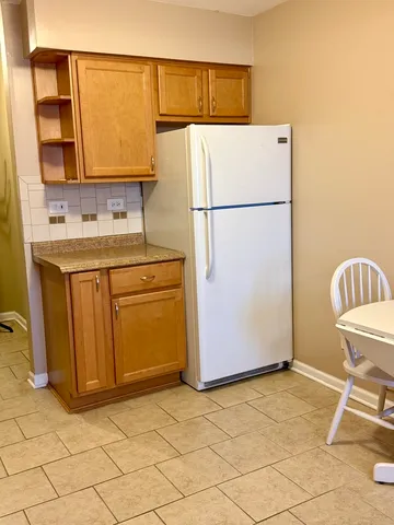 a kitchen with a refrigerator sink and cabinets