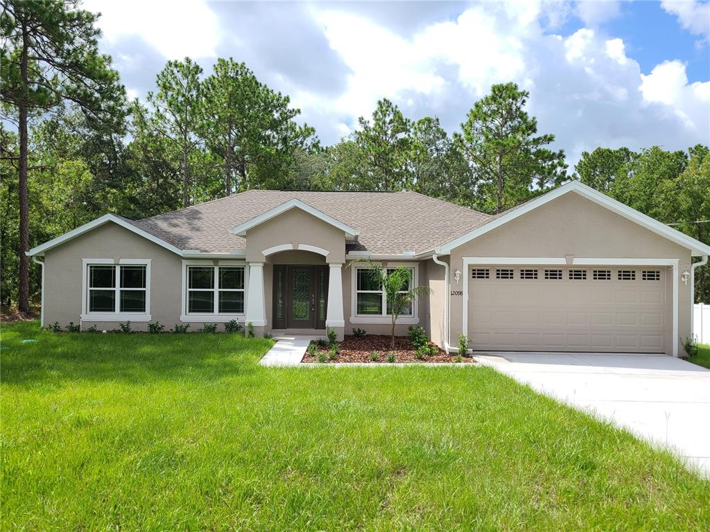 15304 Mt Sparrow Road Weeki Wachee, FL 34614 - Photo 1 of 1 a house with garden in front of it